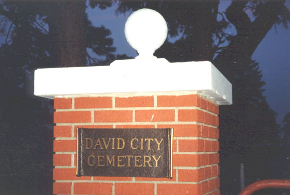 Photo of red brick entrance with white finial and brass plaque